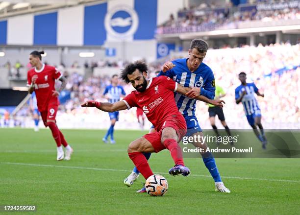 Mohamed Salah of Liverpool competing with Solly March of Brighton and Hove Albion during the Premier League match between Brighton & Hove Albion and...