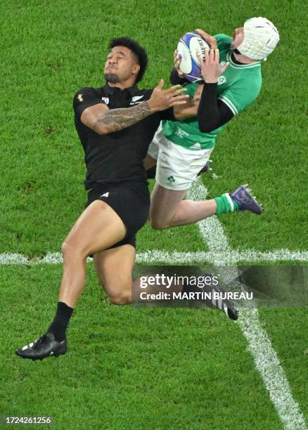 New Zealand's left wing Leicester Fainga'anuku and Ireland's right wing Mack Hansen compete for a high ball during the France 2023 Rugby World Cup...