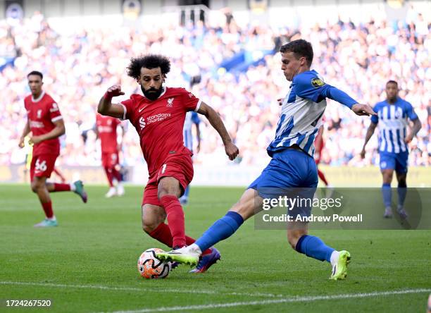 Mohamed Salah of Liverpool competing with Solly March of Brighton and Hove Albion during the Premier League match between Brighton & Hove Albion and...