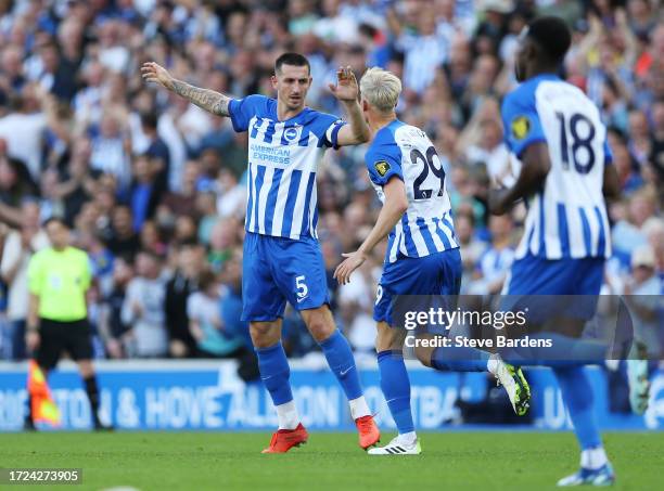 Lewis Dunk of Brighton & Hove Albion celebrates with teammate Jan Paul van Hecke after scoring the team's second goal during the Premier League match...