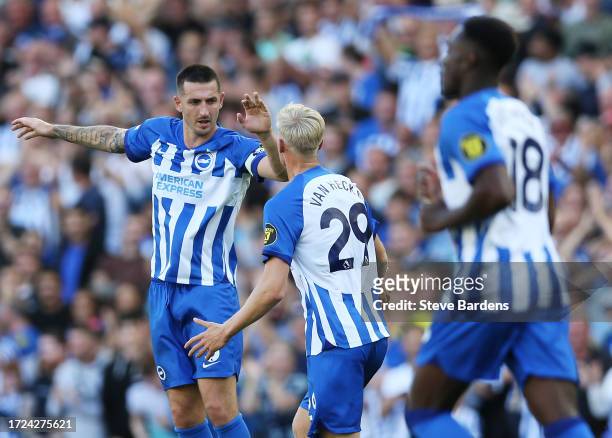 Lewis Dunk of Brighton & Hove Albion celebrates with teammate Jan Paul van Hecke after scoring the team's second goal during the Premier League match...