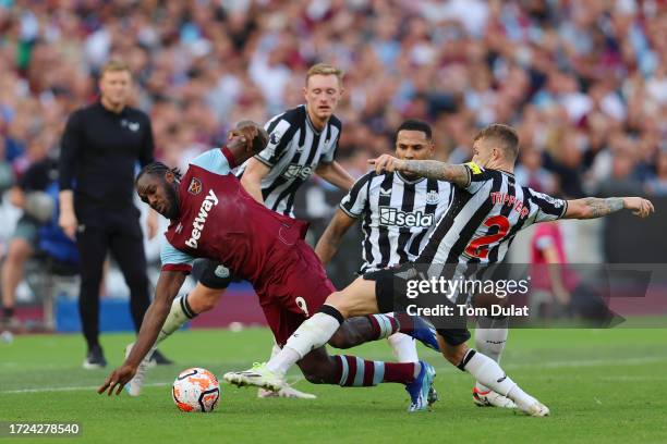 Michail Antonio of West Ham United is challenged by Kieran Trippier of Newcastle United during the Premier League match between West Ham United and...