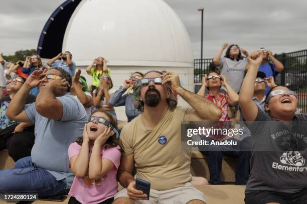 People watch the Annular Solar Eclipse with using safety glasses in Brownsville, Texas, United States on October 14, 2023.