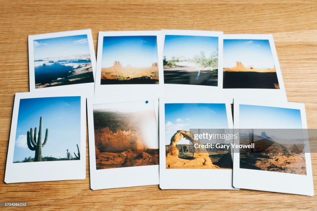Collection of instant film travel photos laid out on a table