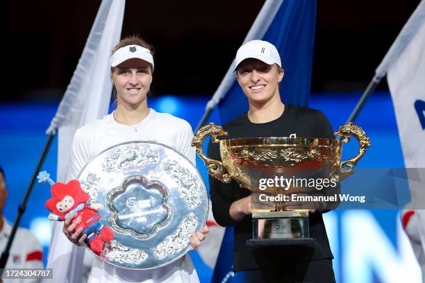 Iga Swiatek of Poland and Liudmila Samsonova pose with the trophy after the medal ceremony following the Women's Singles final match on day 13 of the...