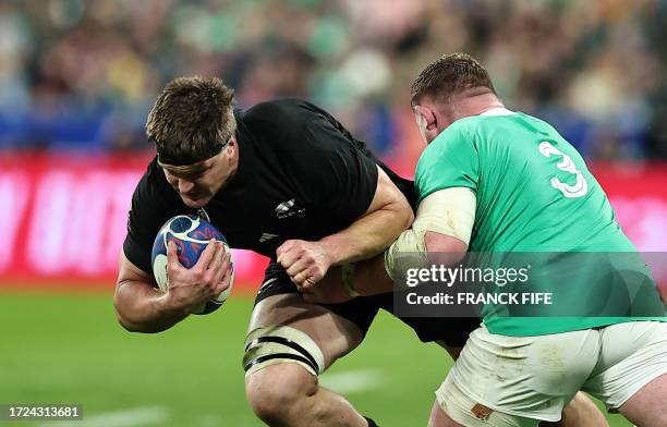 New Zealand's lock Scott Barrett runs with the ball as Ireland's tighthead prop Tadhg Furlong attempts to block during the France 2023 Rugby World...