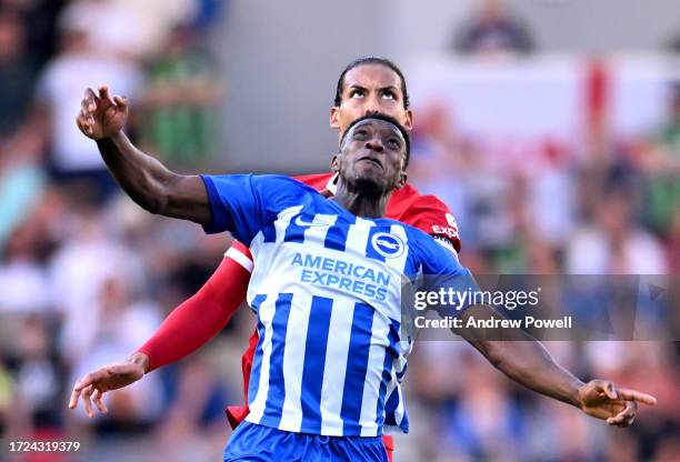 Virgil van Dijk captain of Liverpool goes up with Danny Welbeck of Brighton and Hove Albion during the Premier League match between Brighton & Hove...