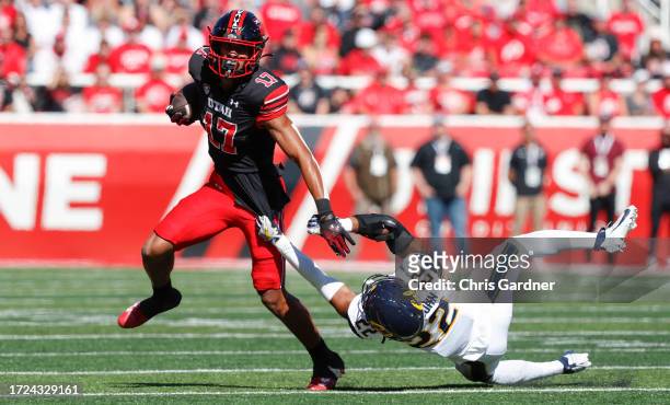 Devaughn Vele of the Utah Utes breaks a tackle attempt by Matthew Littlejohn of the California Golden Bears during the first half of their game at...