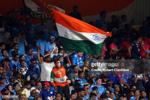 An India fan wearing face paint waves a flag during the ICC Men's Cricket World Cup India 2023 between India and Australia at MA Chidambaram Stadium...