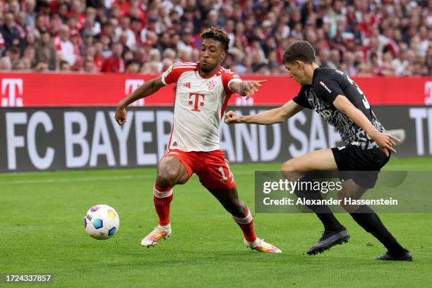 Kingsley Coman of Bayern Munich battles for possession with Merlin Roehl of Sport-Club Freiburg during the Bundesliga match between FC Bayern München...