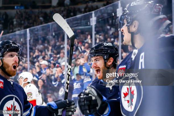 Kyle Connor, Gabriel Vilardi and Mark Scheifele of the Winnipeg Jets celebrate a first period goal against the Florida Panthers at the Canada Life...