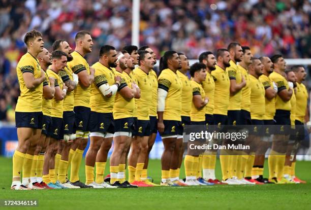 The players or Romania line up during the National Anthems prior to the Rugby World Cup France 2023 match between Tonga and Romania at Stade Pierre...