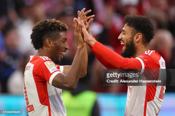 Kingsley Coman of Bayern Munich celebrates with teammate Noussair Mazraoui after scoring the team's first goal during the Bundesliga match between FC...