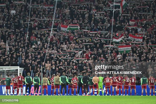 Hungary's players celebrate with their fans after the UEFA Euro 2024 Group G qualification football match Hungary v Serbia at the Puskas Arena of...