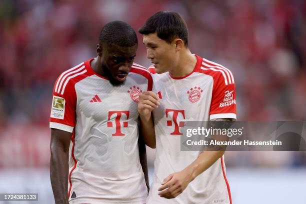 Kim Min-Jae of Bayern Munich talks to teammate Dayot Upamecano during the Bundesliga match between FC Bayern München and Sport-Club Freiburg at...