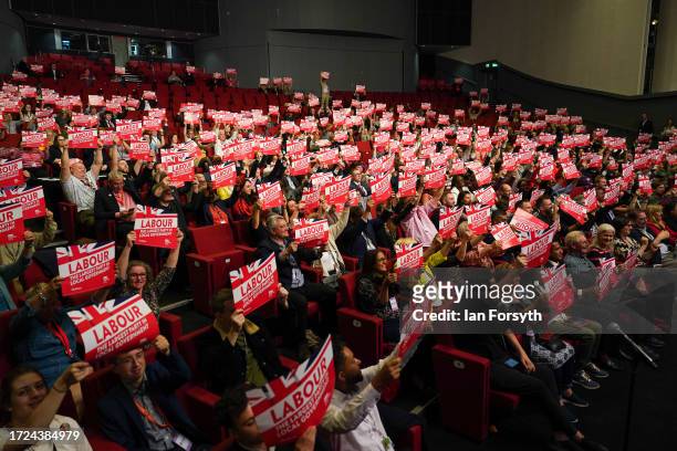 Members of the Local Government Association hold up Labour placards on day one of the Labour Party conference on October 08, 2023 in Liverpool,...