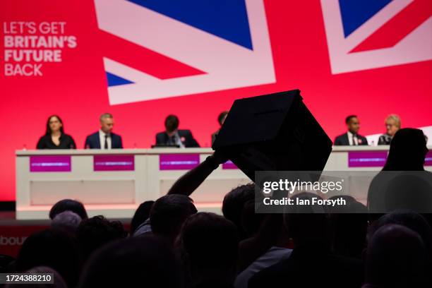 Party members take part in voting on day one of the Labour Party conference on October 08, 2023 in Liverpool, England. The Labour Party go into their...