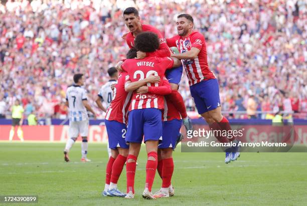 Antoine Griezmann of Atletico Madrid celebrates with teammates after scoring the team's second goal from a penalty during the LaLiga EA Sports match...