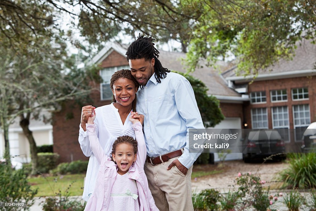 African American family in front of house