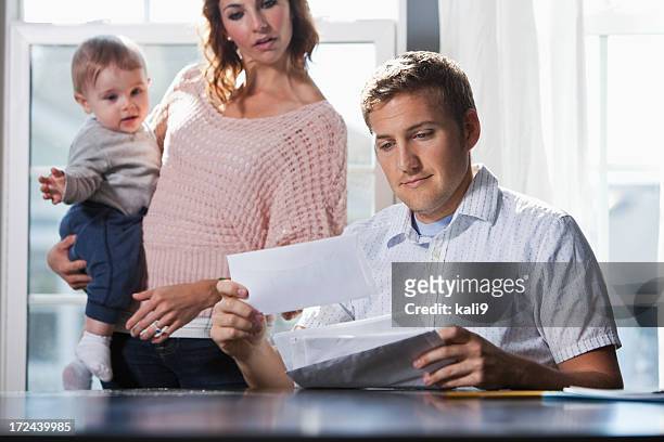 mother and baby, father paying bills - open grave stock pictures, royalty-free photos & images