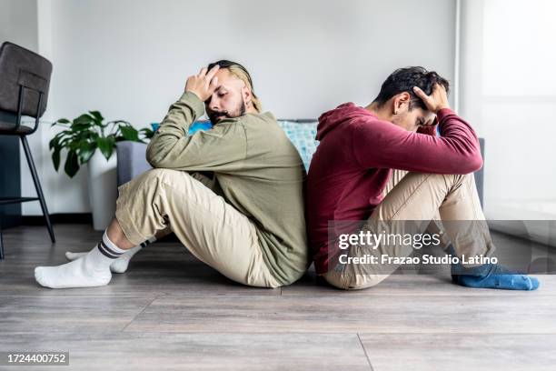 sad gay couple experiencing relationship problems - betrayal stock pictures, royalty-free photos & images