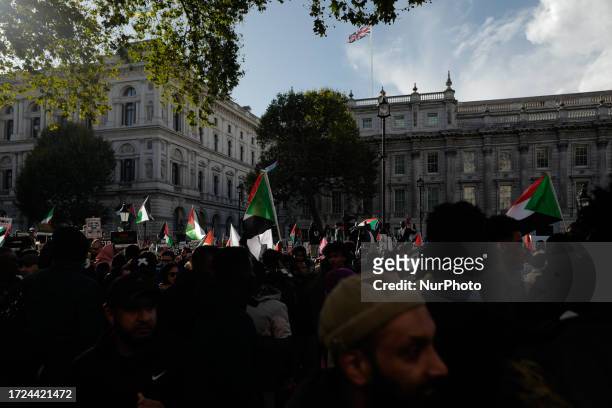 People take part in a march in support of Palestine descending to Whitehall, outside the gates of Downing Street, on October 14, 2023 in London,...