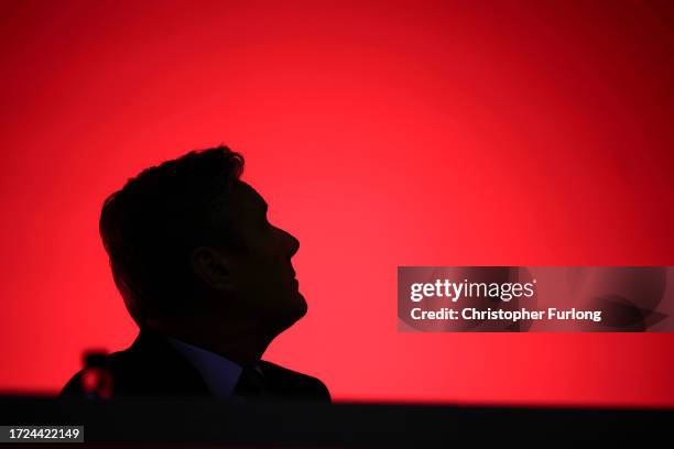 Labour Party leader Sir Keir Starmer is silhouetted as he watches a video screen on day one of the annual Labour party conference on October 08, 2023...