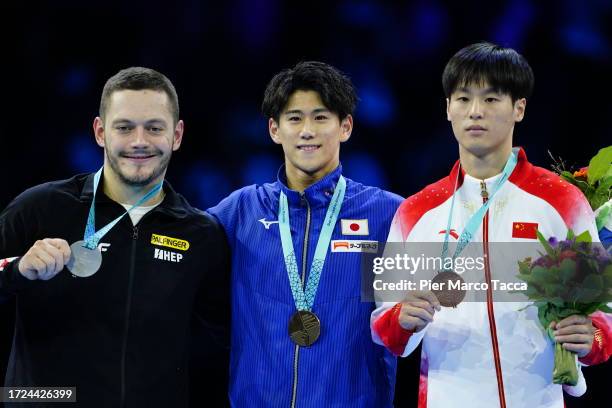 Croatia's Tin Srbic Silver Medal, Japan's Daiki Hashimoto Golden Medal and Bronze Medal China's Weide Su celebrate on the podium after the Men's...