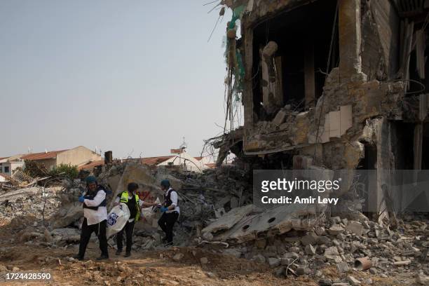 Israeli rescue members work at a police station that was destroyed after a battle between Israeli troops and Hamas militants on October 8, 2023 in...