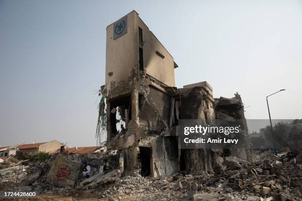 Israeli rescue members work at a police station that was destroyed after a battle between Israeli troops and Hamas militants on October 8, 2023 in...