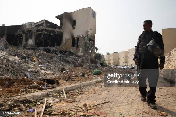 Police Officer walks near a police station that was destroyed after a battle between Israeli troops and Hamas militants that have take the station on...