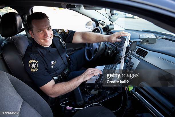 police officer sitting in cruiser - police car stock pictures, royalty-free photos & images