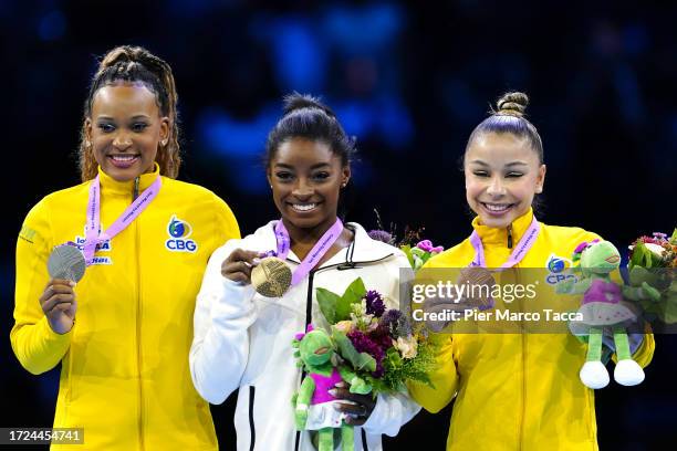 Rebeca Andrade Silver Medal of Brazil, Simone Biles Gold Medal of United States and Flavia Sarawia Bronze Medal of Brazil celebrate on the podium of...