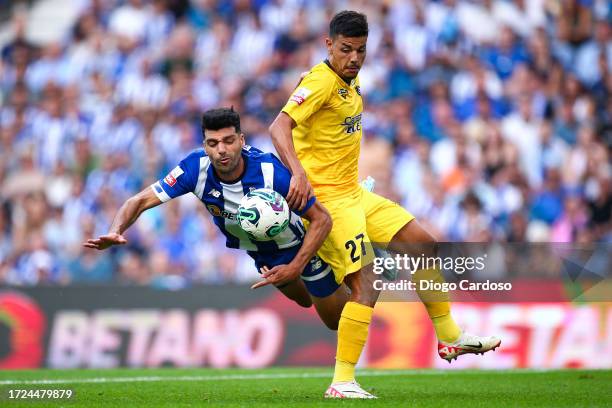 Mehdi Taremi of FC Porto and Guga of Portimonense SC battle for the ball during the Liga Portugal Bwin match between FC Porto and Portimonense SC at...