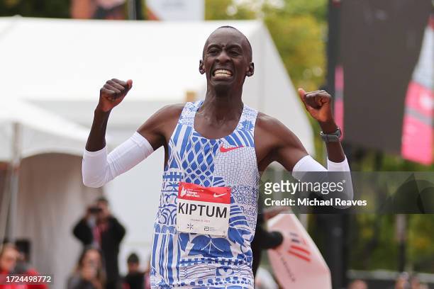 Kelvin Kiptum of Kenya celebrates as he crosses the finish line to win the 2023 Chicago Marathon professional men's division and set a world record...