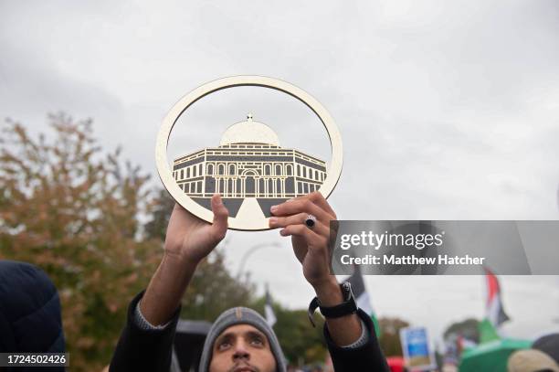 Protestor in support of Palestinians holds up a depiction of the Maqam Ibrahim in a march in support of Palestinians on October 14, 2023 in Dearborn,...