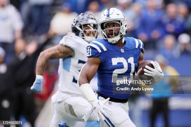 Zack Moss of the Indianapolis Colts runs the ball for a touchdown against the Tennessee Titans during the first quarter at Lucas Oil Stadium on...