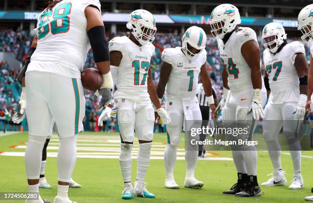 Jaylen Waddle of the Miami Dolphins celebrates with teammates after scoring a touchdown against the New York Giants during the first quarter at Hard...