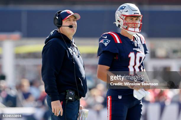 New England Patriots offensive coordinator Bill O'Brien and Mac Jones of the New England Patriots look on during the first quarter against the New...