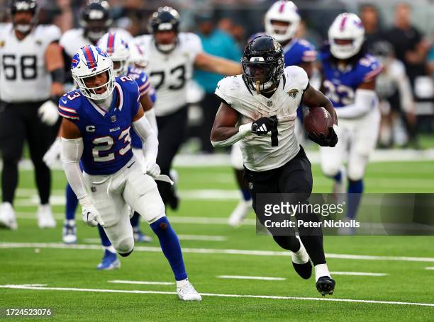 Travis Etienne Jr. #1 of the Jacksonville Jaguars runs with the ball in the Fourth Quarter during the NFL Match between Jacksonville Jaguars and...