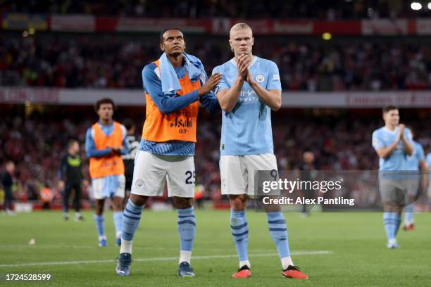 Manuel Akanji and Erling Haaland of Manchester City applaud fans following the Premier League match between Arsenal FC and Manchester City at...