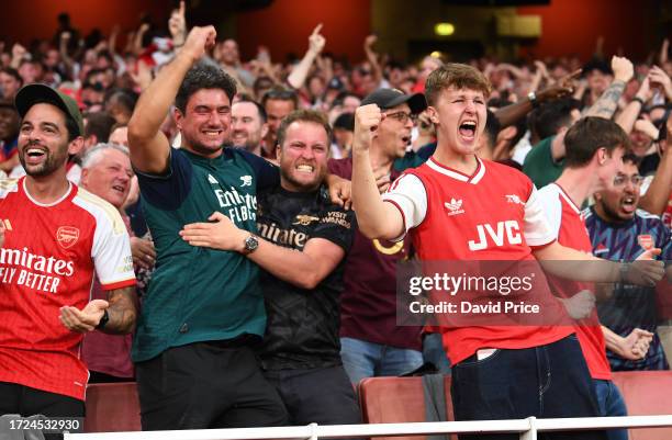 Arsenal fans celebrate following their sides victory after the Premier League match between Arsenal FC and Manchester City at Emirates Stadium on...