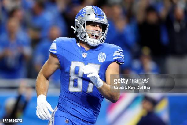 Sam LaPorta of the Detroit Lions celebrates after scoring a touchdown in the second quarter against the Carolina Panthers at Ford Field on October...
