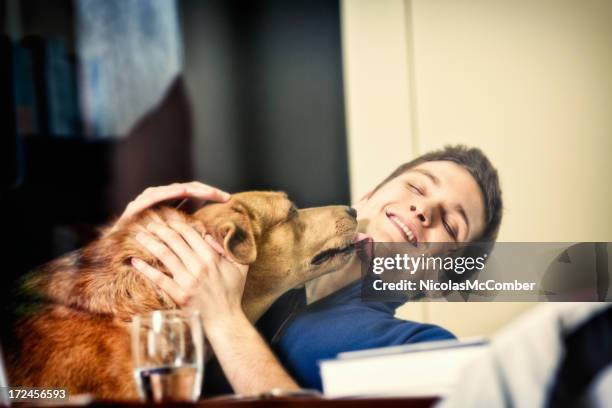 Dog licking his owner