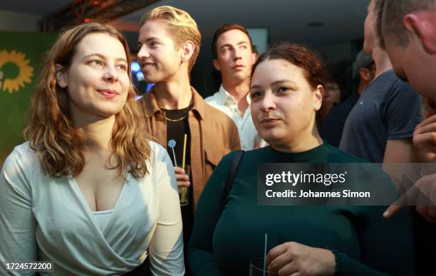 Member of the German parliament Jamila Schaefer and supporters of the Green Party react to initial results in Bavarian state elections following the...