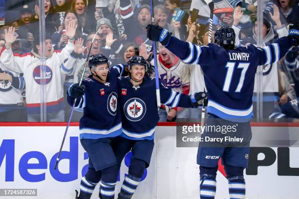 Neal Pionk, Mason Appleton and Adam Lowry of the Winnipeg Jets celebrate a third period short-handed goal against the Florida Panthers at the Canada...