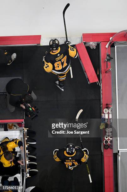Sidney Crosby of the Pittsburgh Penguins and Evgeni Malkin of the Pittsburgh Penguins take the ice against the Calgary Flames at PPG PAINTS Arena on...