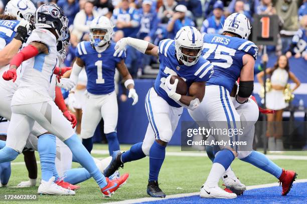 Zack Moss of the Indianapolis Colts scores a rushing touchdown against the Tennessee Titans during the / at Lucas Oil Stadium on October 08, 2023 in...