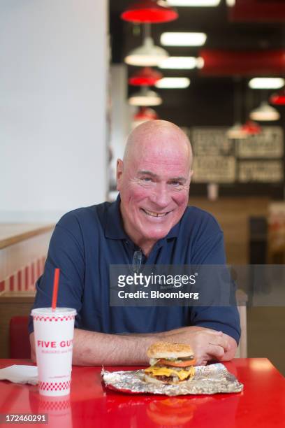 Jerry Murrell, founder of Five Guys, poses for a photograph inside the company's new hamburger outlet in London, U.K., on Tuesday, July 2, 2013. Five...