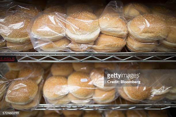 Hamburger bread rolls sit in packaging on shelves ahead of use in the kitchen at the first U.K. Outlet of U.S. Burger restaurant chain Five Guys in...